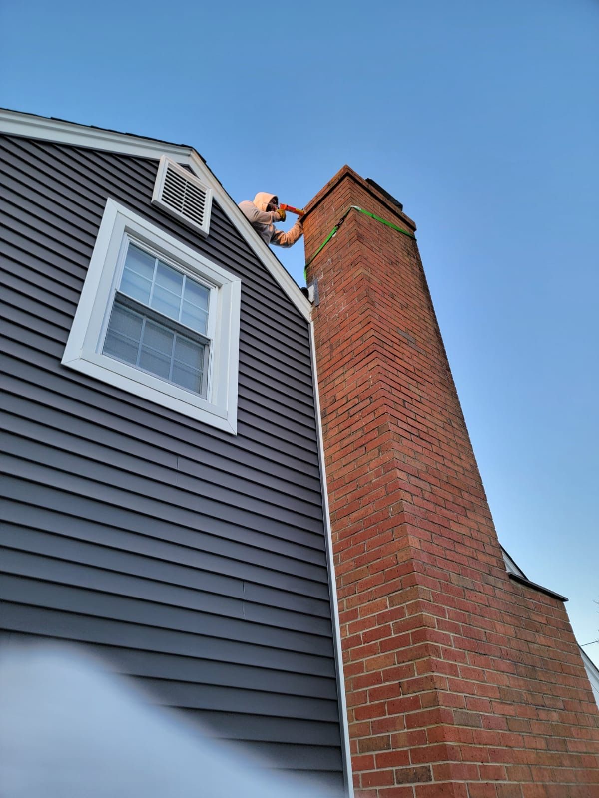 A masonry chimney crown photographed from the roof during a sweep