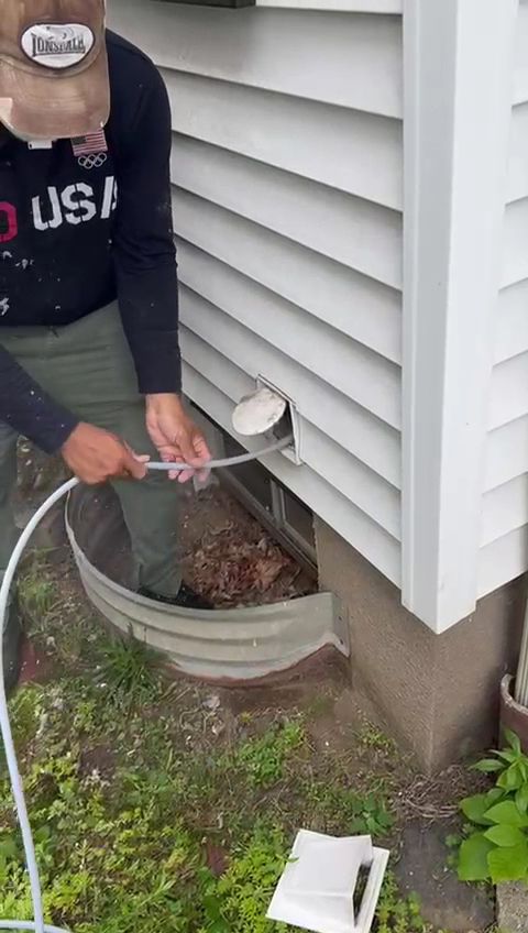 AMG technician clearing and repairing a debris-filled foundation vent duct