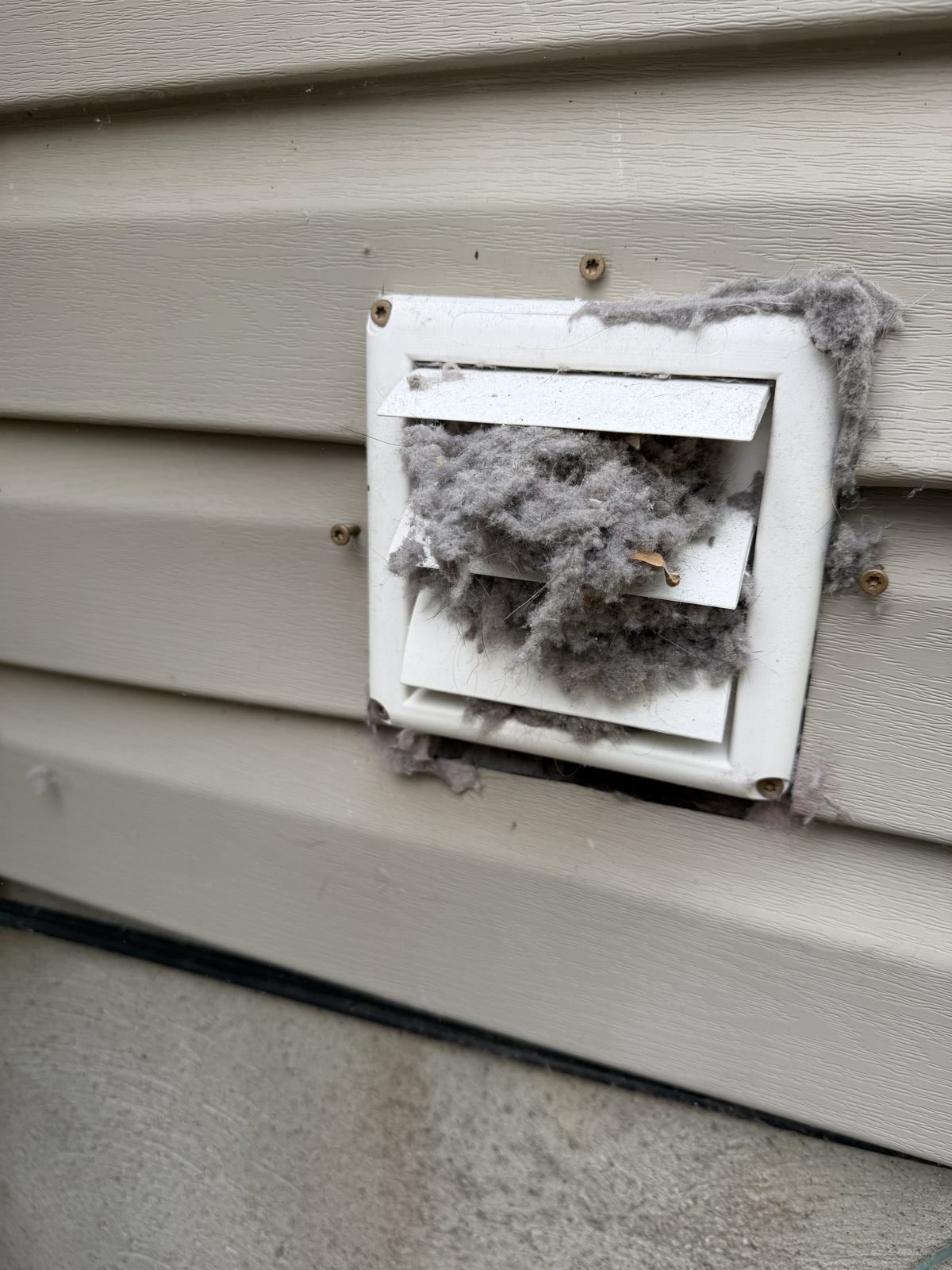 A ceiling vent packed with lint before AMG cleaning. AMG at work for homes in Essex Fells, New Jersey.