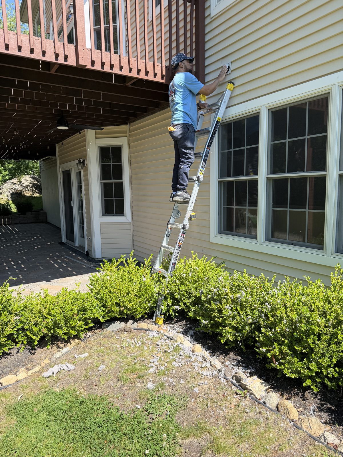 An AMG technician on a ladder at a New Jersey home. AMG at work for homes in Bridgewater, New Jersey.