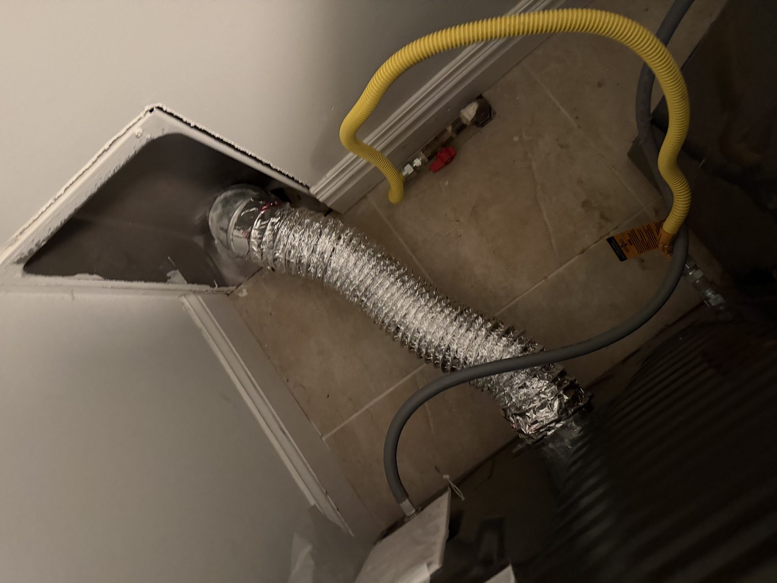 Ductwork connected to an AMG cleaning hose. AMG at work for homes in Teaneck, New Jersey.
