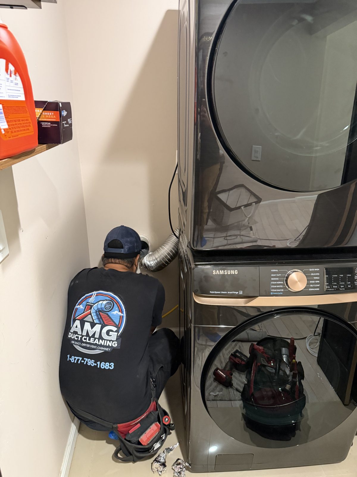 An AMG technician servicing a dryer in a New Jersey home. AMG at work for homes in Bernards, New Jersey.